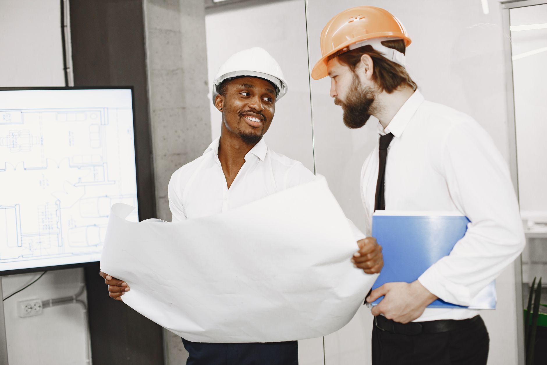 Contractor reviewing a home renovation budget and blueprint