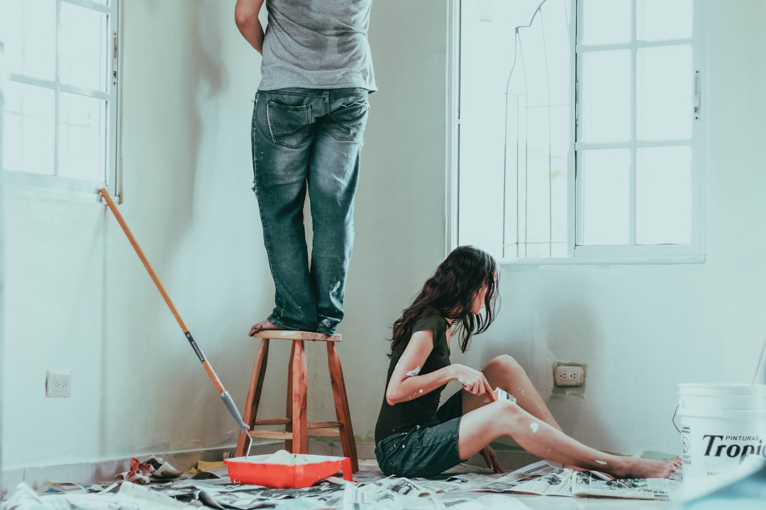 Person painting a wall as a budget-friendly DIY remodel step