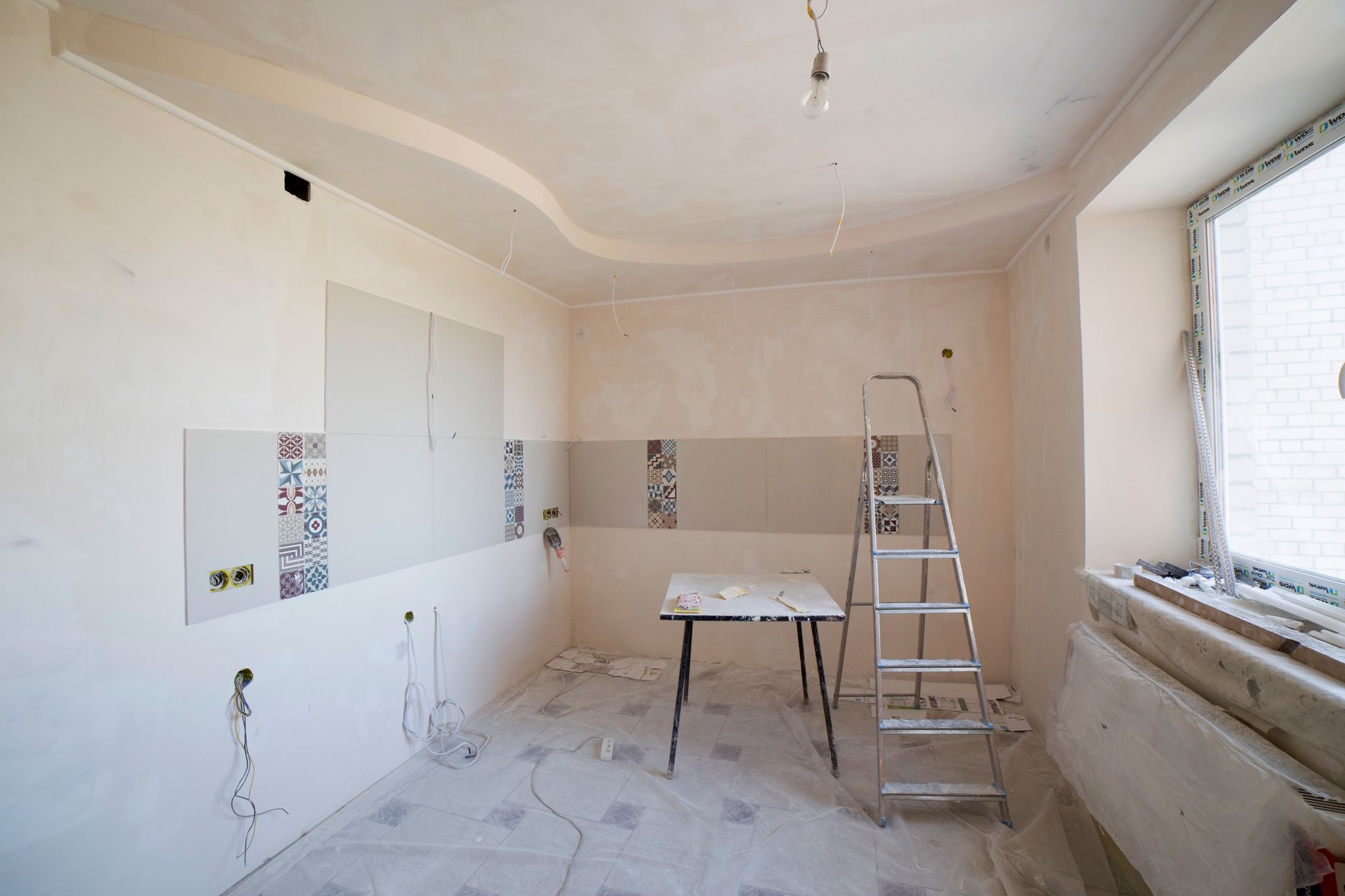 Room before and after a home remodel showing a structural layout change