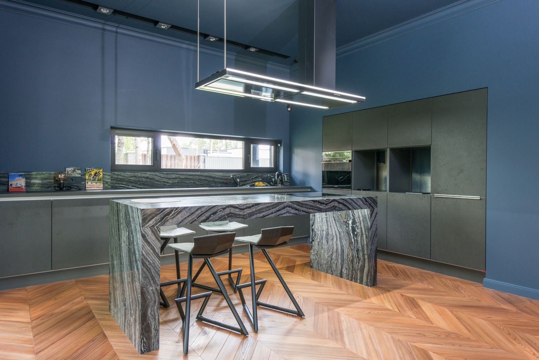 Modern kitchen island with pendant lighting after a remodel
