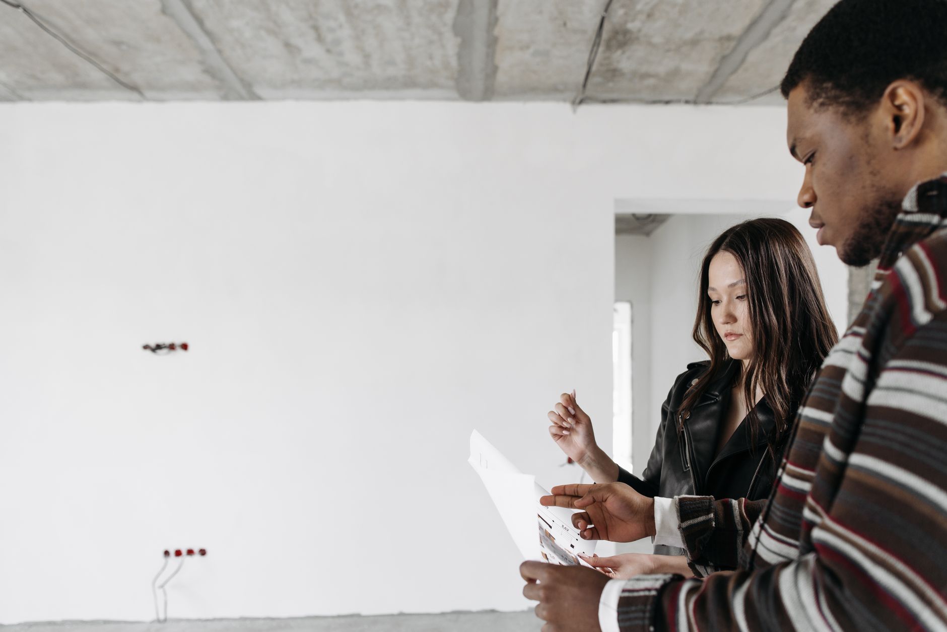 Homeowner planning a renovation with blueprints and a checklist