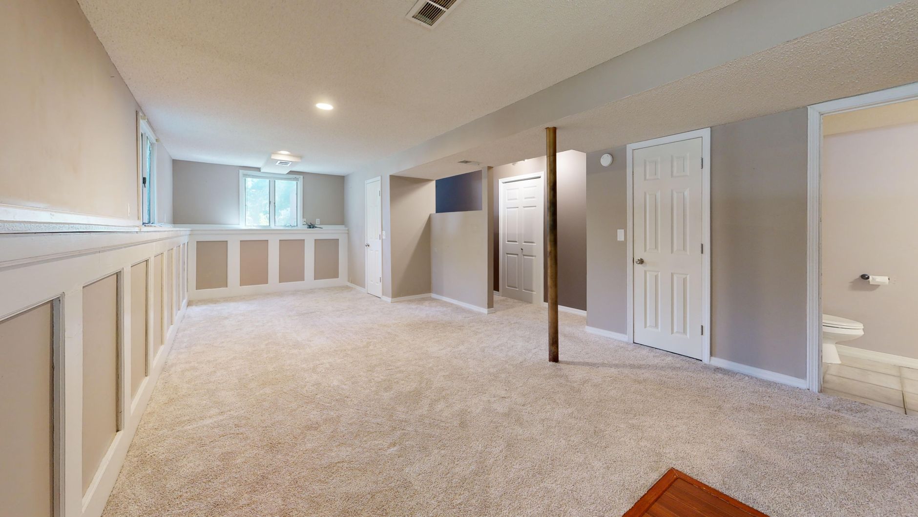 Renovated open-concept living room with new flooring and lighting