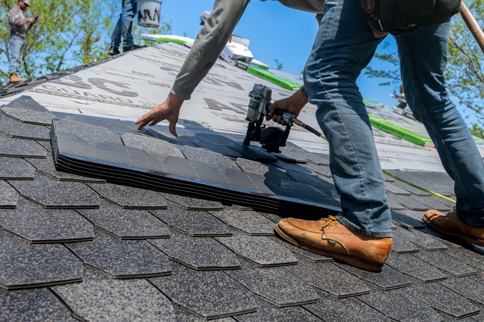 Roofing contractor installing new shingles